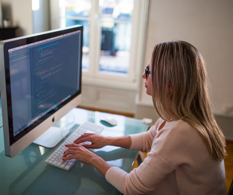 Lady doing coding on computer